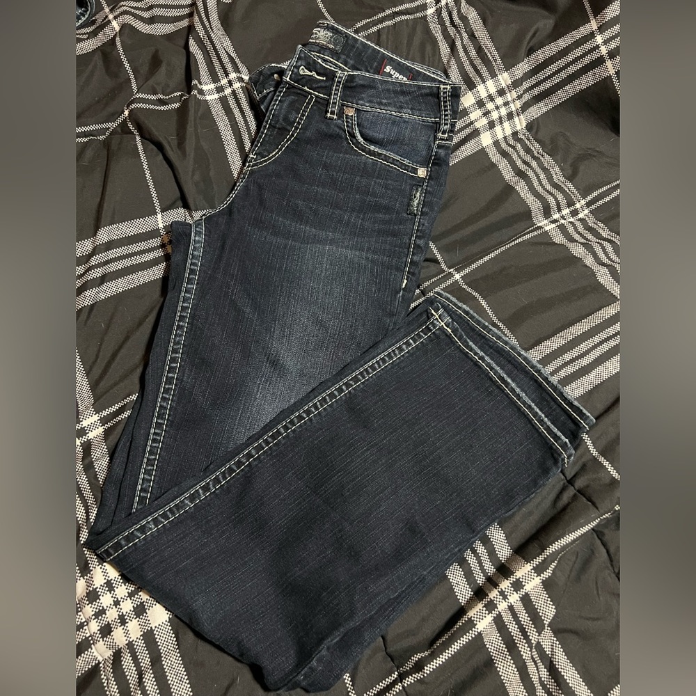 Ladies silver boot cut jeans.